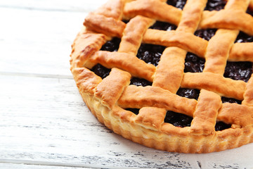 Homemade pie on white wooden background
