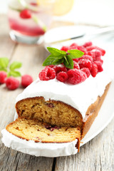Raspberry cake on plate on grey wooden background