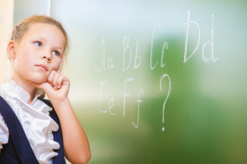 Schoolgirl wrote in chalk on blackboard and teach English language