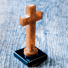 Beautiful old cross with jesus on the old wooden floor