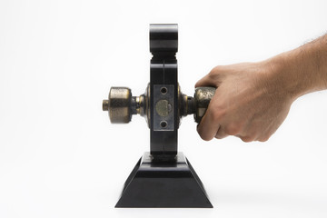 Aluminium door knob on the black door white background.