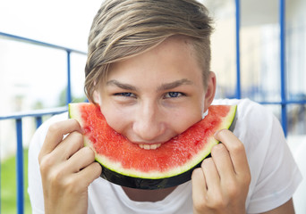 Boy eats a watermelon