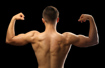 Muscle young man on dark background