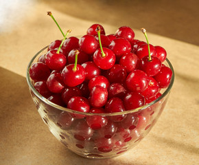 glass bowl full of red ripe cherries
