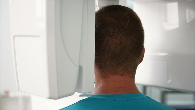 man undergoing tests on dental X-Ray scanner