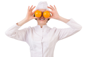 Pretty female doctor holding orange isolated on white