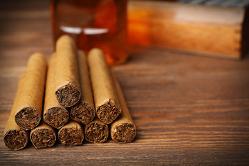 Cigars on wooden table, closeup