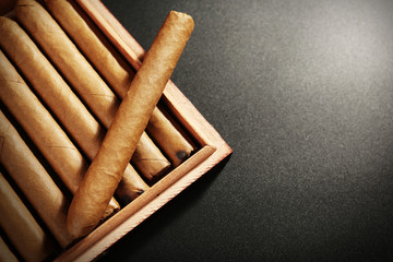 Collection of cigars in humidor on black table, closeup