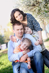Naklejka na ściany i meble Happy family with two children in spring