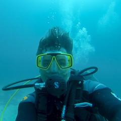 Naklejka na ściany i meble Underwater man diving scuba in Pacific Ocean