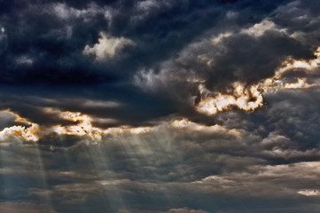 Fototapeta na wymiar Stormy sky with a dramatic sunbeams