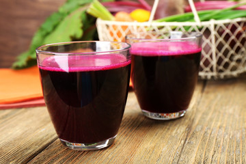 Glasses of beet juice on table close up