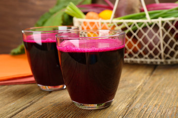Glasses of beet juice on table close up
