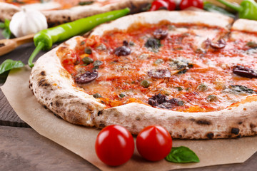Delicious pizzas on wooden table, closeup