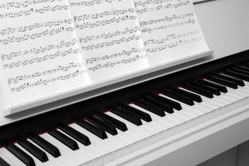 Piano with music notes close up