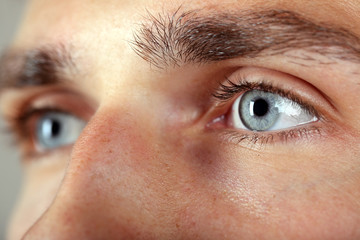 Obraz premium Beautiful blue man eyes close up
