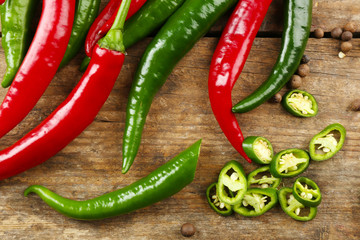 Hot peppers on wooden table close up