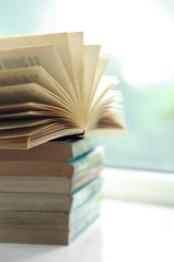 Books on white windowsill, close up