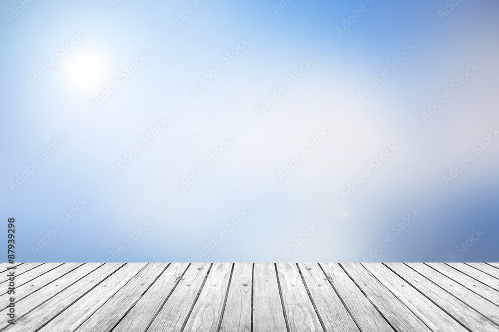 Wall mural wooden floor with blue sky blurred background