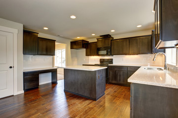 Modern kitchen with stained cabinets.
