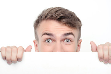 Curious man emerging from white board