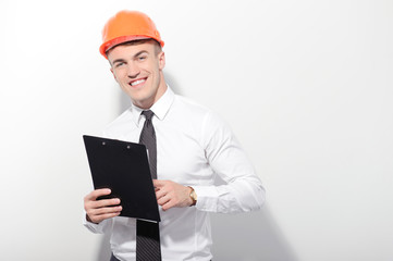 Smiling foreman holding folder on isolated