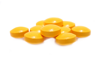 pill of vitamin C on white background