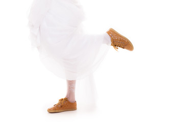 Wedding. Running bride woman legs in sport shoes