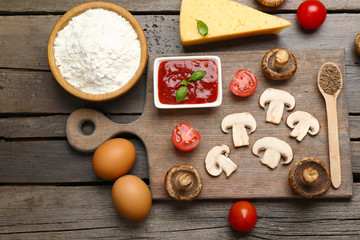 Food ingredients for pizza on table close up