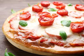 Delicious pizza with cheese and cherry tomatoes, closeup