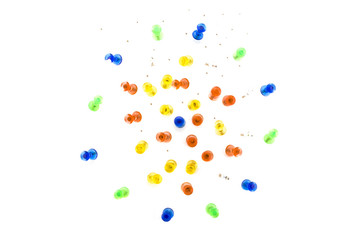 Colourful mass of stationery pins, holes on background paper