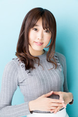 Naklejka premium attractive asian woman on blue background