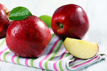 Ripe red apples on table close up