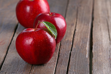Ripe red apples on table close up