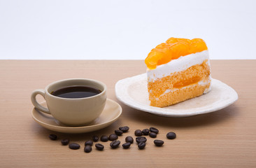 cup of coffee and delicious cake on white background