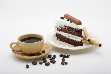 cup of coffee and delicious cake on white background