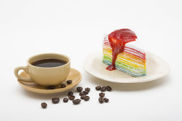 cup of coffee and delicious cake on white background
