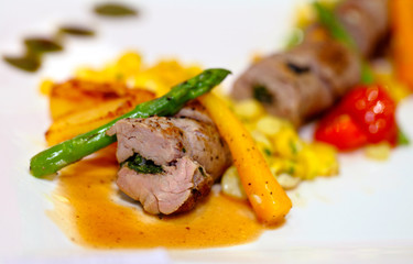 Steak Rolls with vegetables on white dish