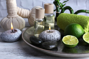 Beautiful composition of spa treatment on tray, on light background