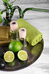 Beautiful composition of spa treatment on tray, on light background