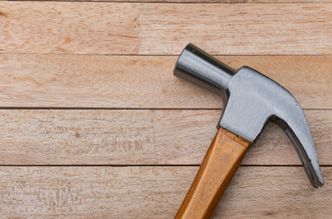 Hammer on wood background with copy space