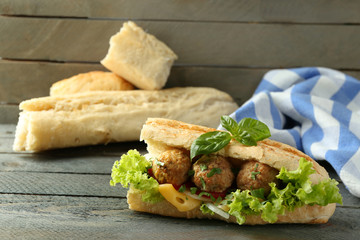 Homemade Spicy Meatball Sub Sandwich on wooden table background