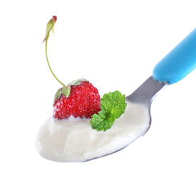 Delicious yogurt in spoon with strawberry and mint isolated on white
