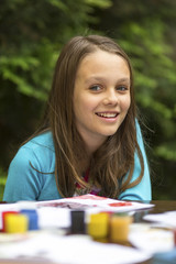 Portrait of little girl during painting paints.