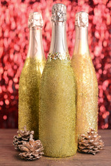 Bottles of champagne with Christmas decoration on bright background