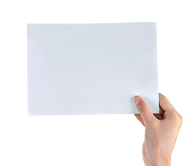 Obraz premium Female hand holding paper blank isolated on white