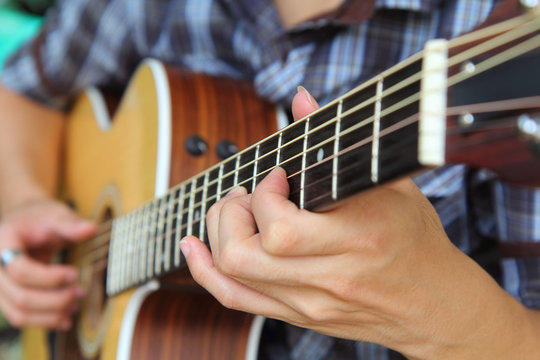 Close up to the hand of guitar player / soft focus