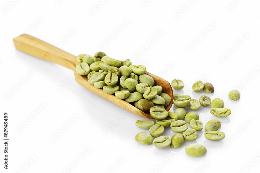 Canvas Prints green coffee beans in wooden spoon isolated on white