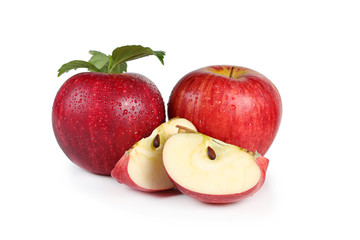 fresh red apples with leaves isolated on white background