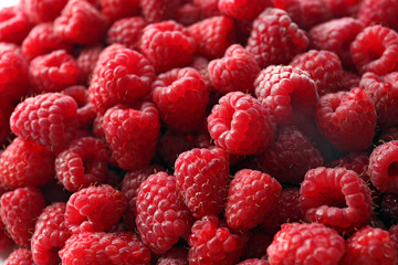 Heap of sweet red raspberries close up